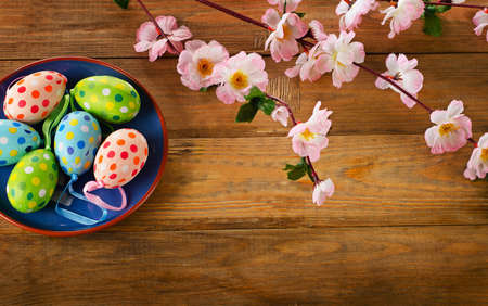 Colorful Easter eggs on  wooden background. Top view.