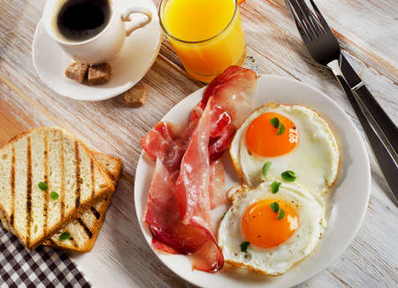 Fried Eggs , bacon and coffee for healthy breakfast .の写真素材
