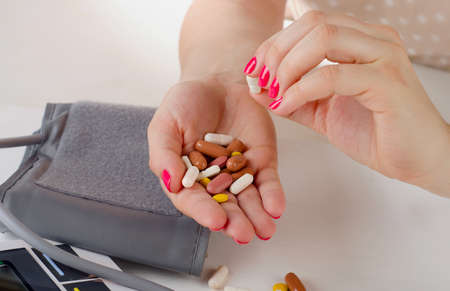 Young Woman hands holding   pills. Selective focusの写真素材