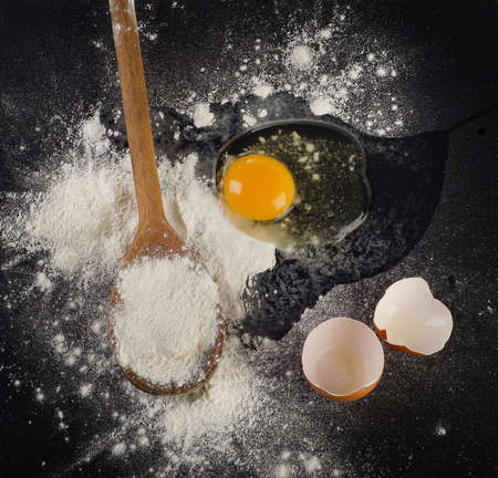 Baking background with egg, eggshell  and flour. top viewの写真素材