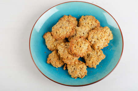 Freshly baked oatmeal cookies in a blue plate. Top viewの写真素材