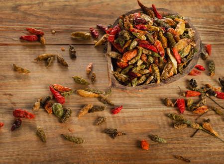 Chili peppers on a rustic wooden board.の写真素材