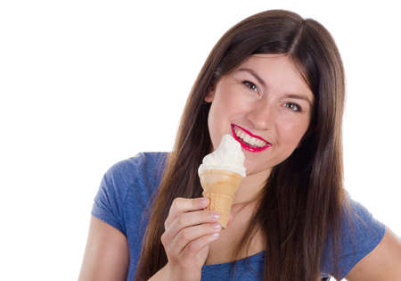 Portrait of young happy woman eating ice-cream isolated on a white backgroundの写真素材