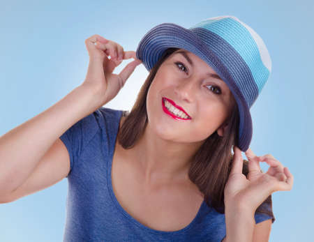 Portrait of young woman  on a blue backgroundの写真素材