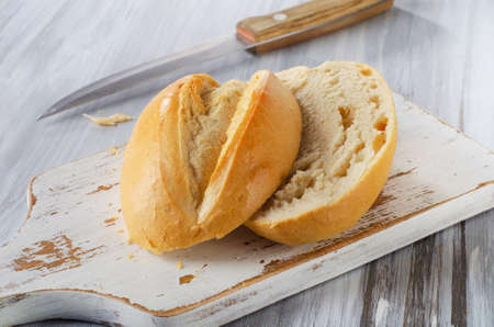 Fresh bread on a white wooden table.の写真素材