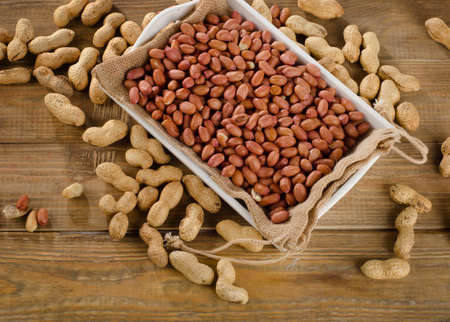 Peanuts on a old wooden background. Top view
