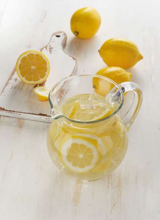 Water with fresh lemon and ice in  glass jug. Selective focusの写真素材