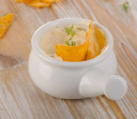 Cheese Sauce with chips on  a wooden table. Selective focusの写真素材