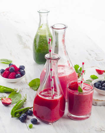 Healthy fruits and vegetables smoothies in glass bottles for breakfast. Selective focusの写真素材