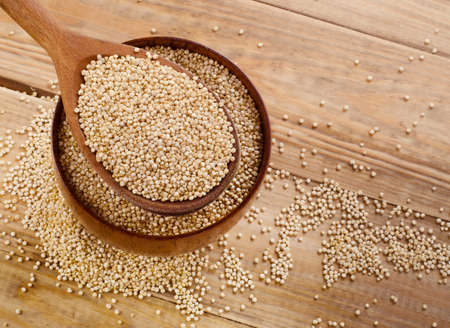 Quinoa seed in  a wooden spoon. Top view