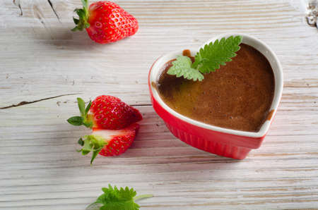 Homemade Chocolate Mousse  in a heart-shaped bowl on wooden table. Selective focusの写真素材