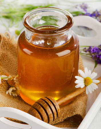 Full honey jar and honey stick. Selective focusの写真素材