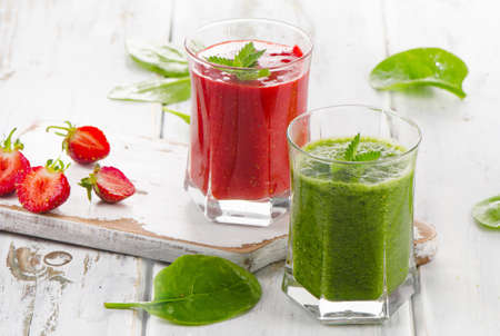 Healthy Spinach and strawberry smoothies on a whitewooden table. Selective focusの写真素材