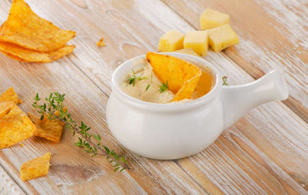 Cheese Sauce with Nachos on  wooden background. Selective focusの写真素材