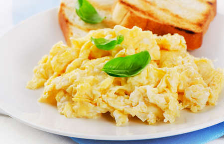 Scrambled eggs with fresh basil. Selective focusの写真素材