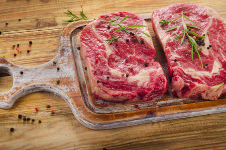 Steak Ribeye  on a old cutting board.の写真素材