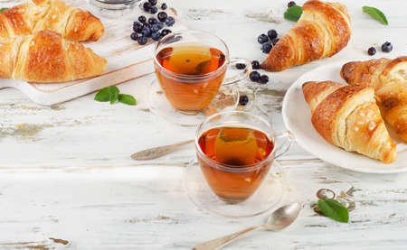 Fresh croissants and cups of tea  for breakfast.の写真素材