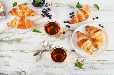 Fresh croissants and cups of tea  for breakfast. Top viewの写真素材