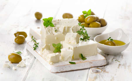 Feta cheese with green olives and fresh herbs. Selective focusの写真素材