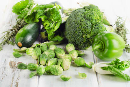 Fresh green vegetables on a white wooden table. Selective focusの写真素材