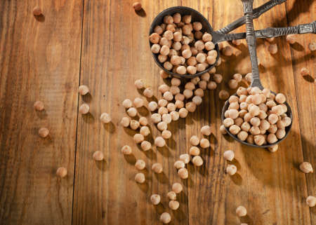 Chickpeas on old wooden background. Selective Focus