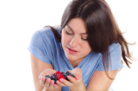 Beautiful girl with fresh berries, isolated on white backgroundの写真素材