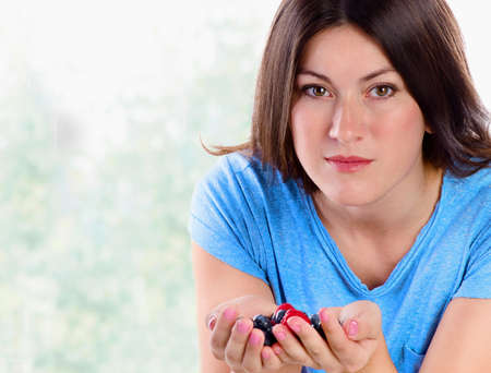 Young smiling woman with berries. Healthy food.の写真素材