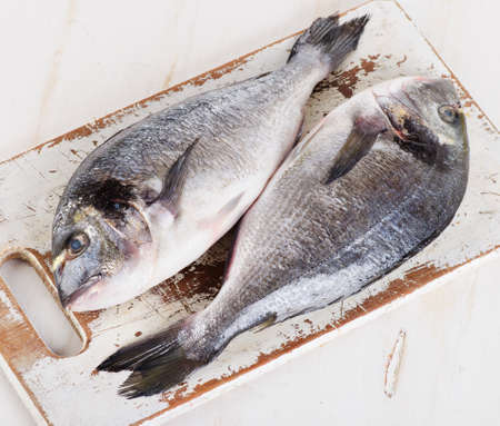 Fresh dorado fish on cutting board. Top viewの写真素材