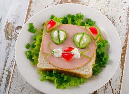 Breakfast with a smiling toast and fresh vegetables. Top viewの写真素材