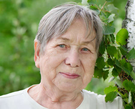 Portrait of senior woman outdoors in a summer