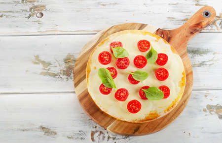 Italian Pizza on a wooden table. Top viewの写真素材