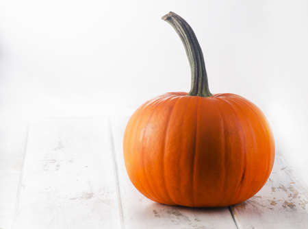 Autumn halloween pumpkin on a wooden table. Selective focusの写真素材