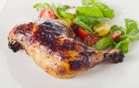 Roasted chicken leg with fresh salad. Selective focusの写真素材