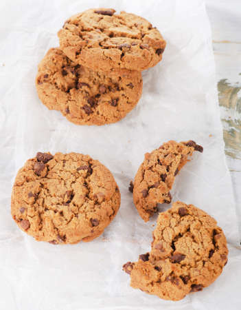 Chocolate chip cookies on white paper. Selective focus