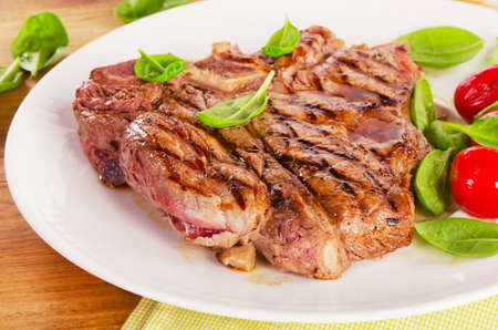 T-bone steak served with  fresh green salad and a BBQ  ketchup. Selective focusの写真素材