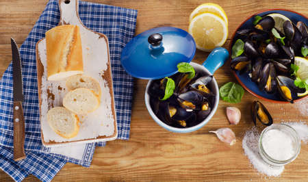Plate of steamed mussels on a wooden background. View from aboveの写真素材