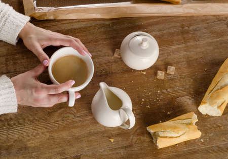 Woman Hand holding espresso Coffee cup. Top viewの写真素材