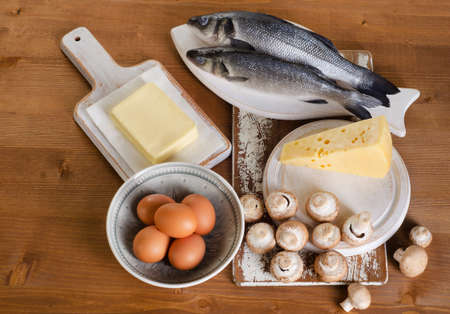 Foods containing vitamin D on wooden table. View from aboveの写真素材