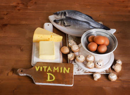 Foods containing vitamin D on a wooden background. View from aboveの写真素材