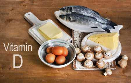 Foods containing vitamin D on a wooden table. View from aboveの写真素材