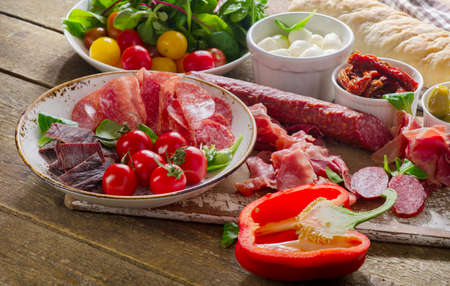 Traditional italian antipasto on a wooden board. Selective focus