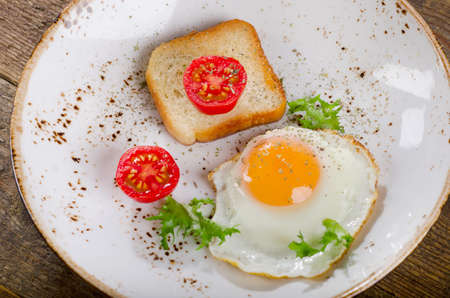 Breakfast with egg, toast and tomatoes. Top viewの写真素材