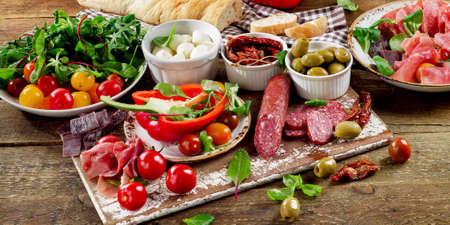 Appetizers on a wooden cutting board.の写真素材