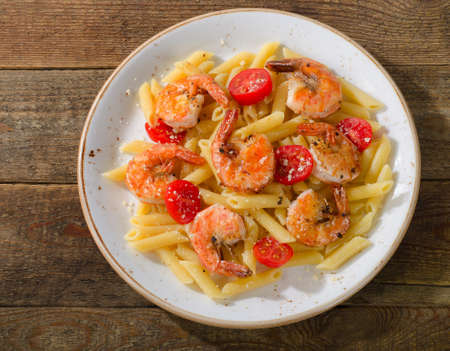 Penne pasta with shrimps and tomatoes. Top viewの写真素材