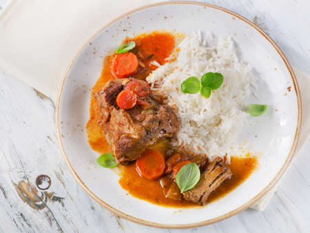 Slow Cooked Beef with rice and vegetables on plate. Top viewの写真素材