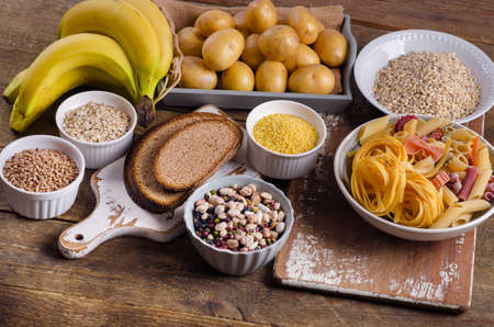 Foods high in carbohydrate on rustic wooden background. Top viewの写真素材
