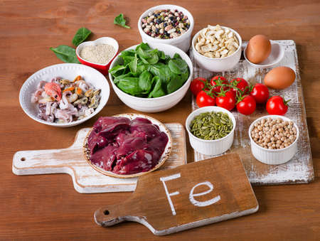 Foods high in Iron, including eggs, nuts, spinach, beans, seafood, liver, chickpeas.の写真素材