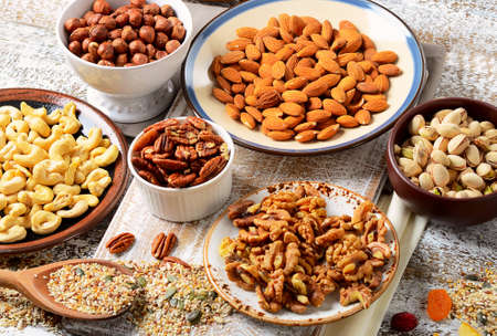 Assorted mixed nuts on wooden table.の写真素材