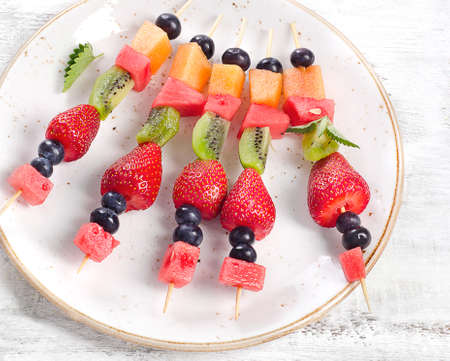 Colorful fresh fruit kebabs on  plate. Healthy eatingの写真素材
