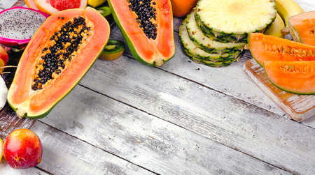 Different raw Exotic tropical fruits on a wooden background. Healthy eating concept.の写真素材
